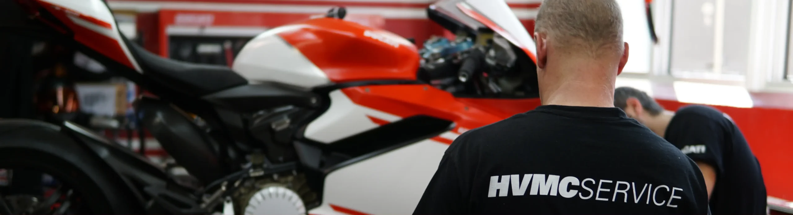 two guys working to repair a motorcycle